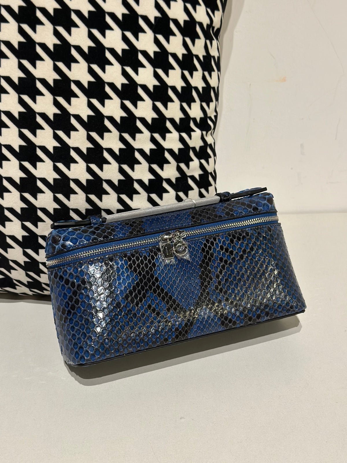 Genuine python skin leather zipper handbag by Rossie Viren with a handle, featuring a luxurious textured surface and compact design.